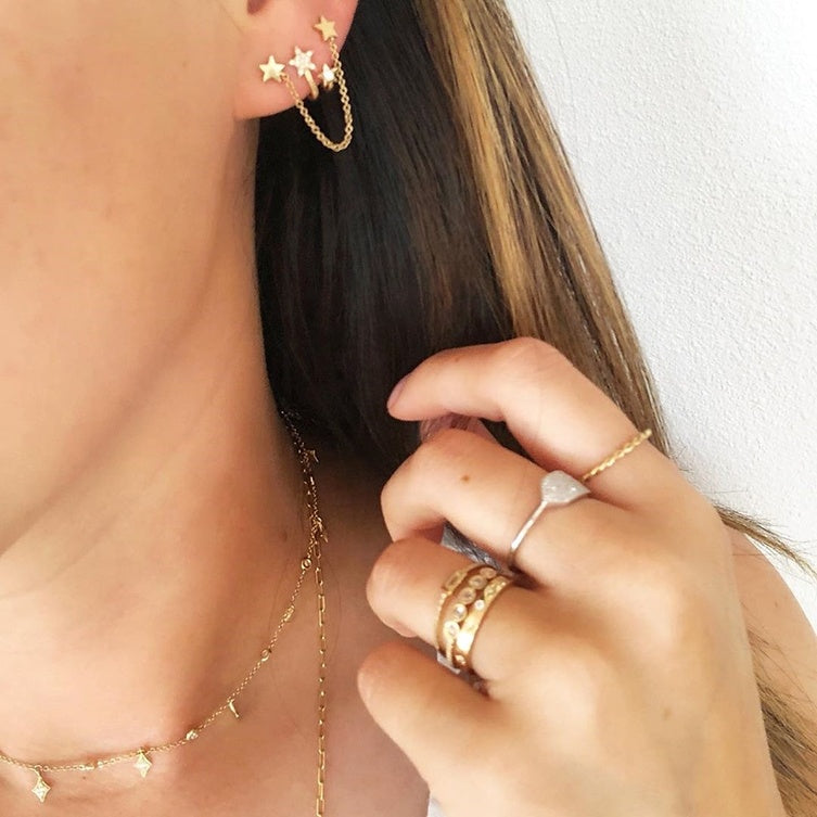 2 star drop earrings on model