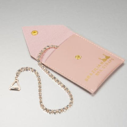 rose gold plated bra straps with crystals in a pink pouch