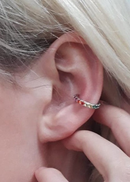 Gold rainbow ear cuff on ear