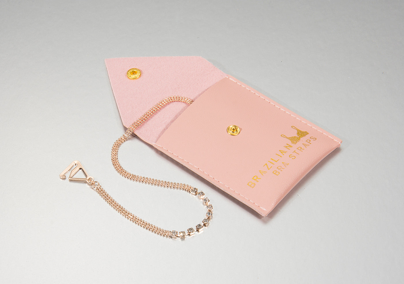 rose gold bra straps on a faux leather pouch for gift