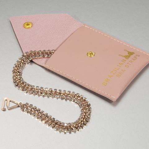 rose gold bra straps on a gift pouch